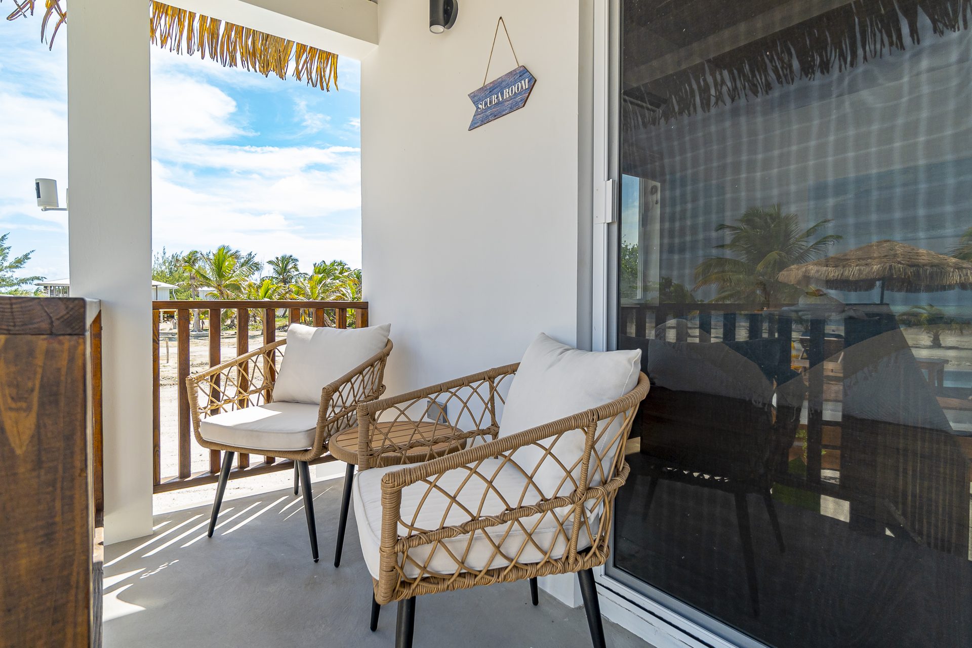 Two rattan chairs on the Scuba Room porch