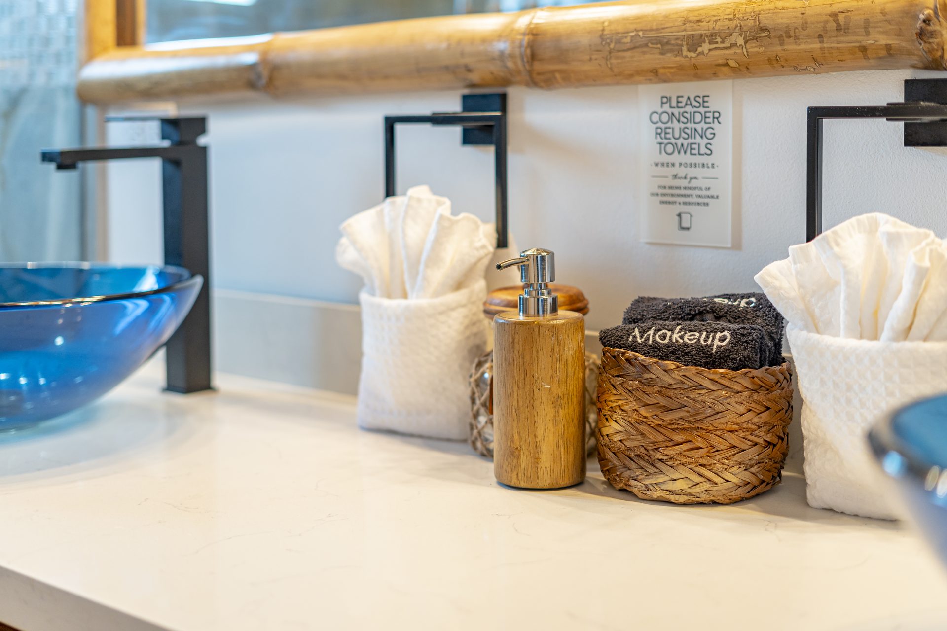 Vanity with rolled towels and toiletries in the Scuba Room
