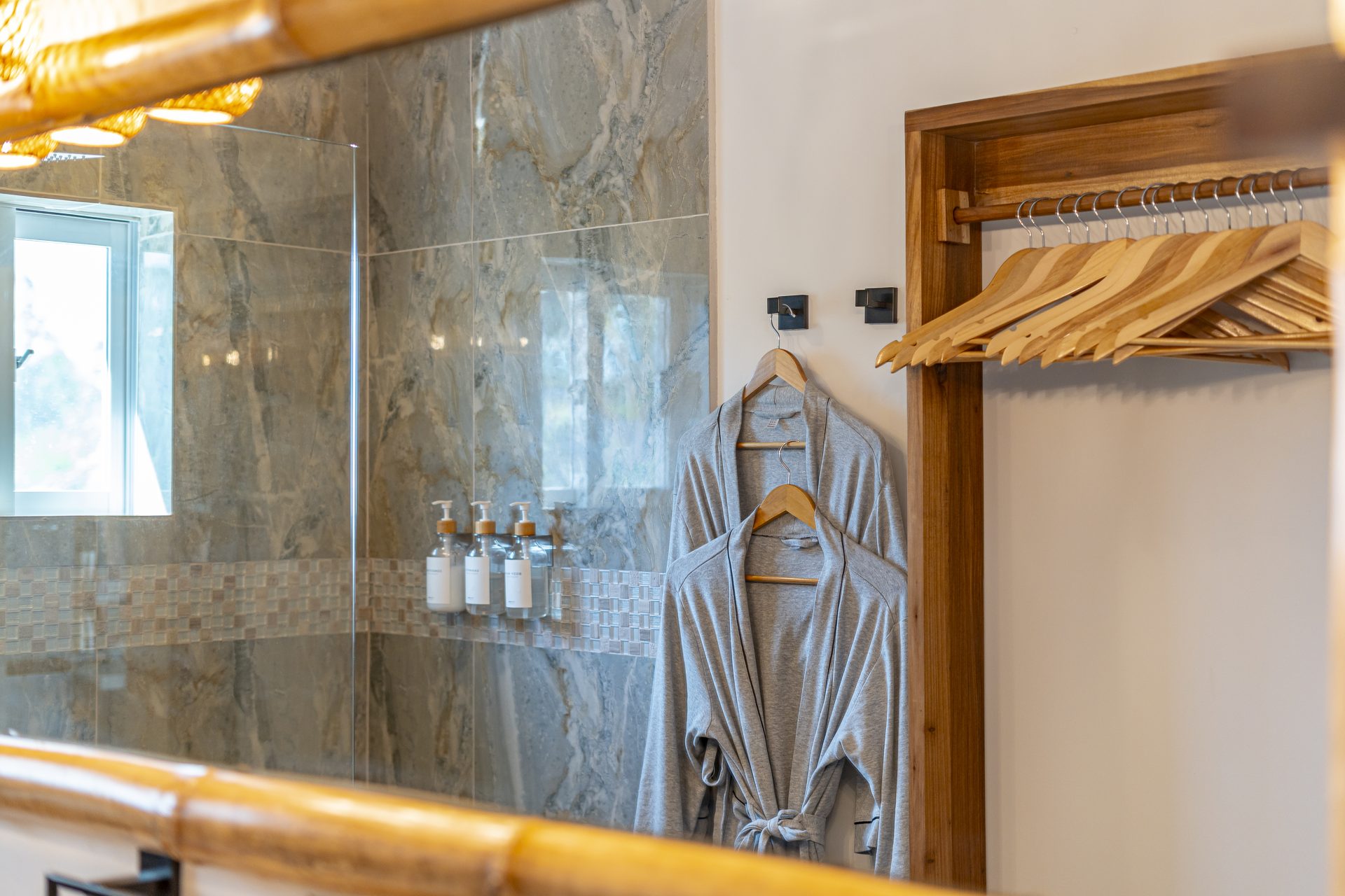 Walk-in shower and robes hanging in the Scuba Room