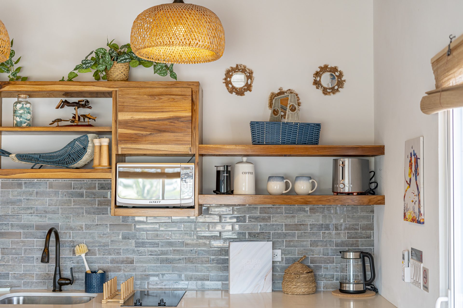 Open wood shelving with mugs and decor in the Scuba Room kitchenette