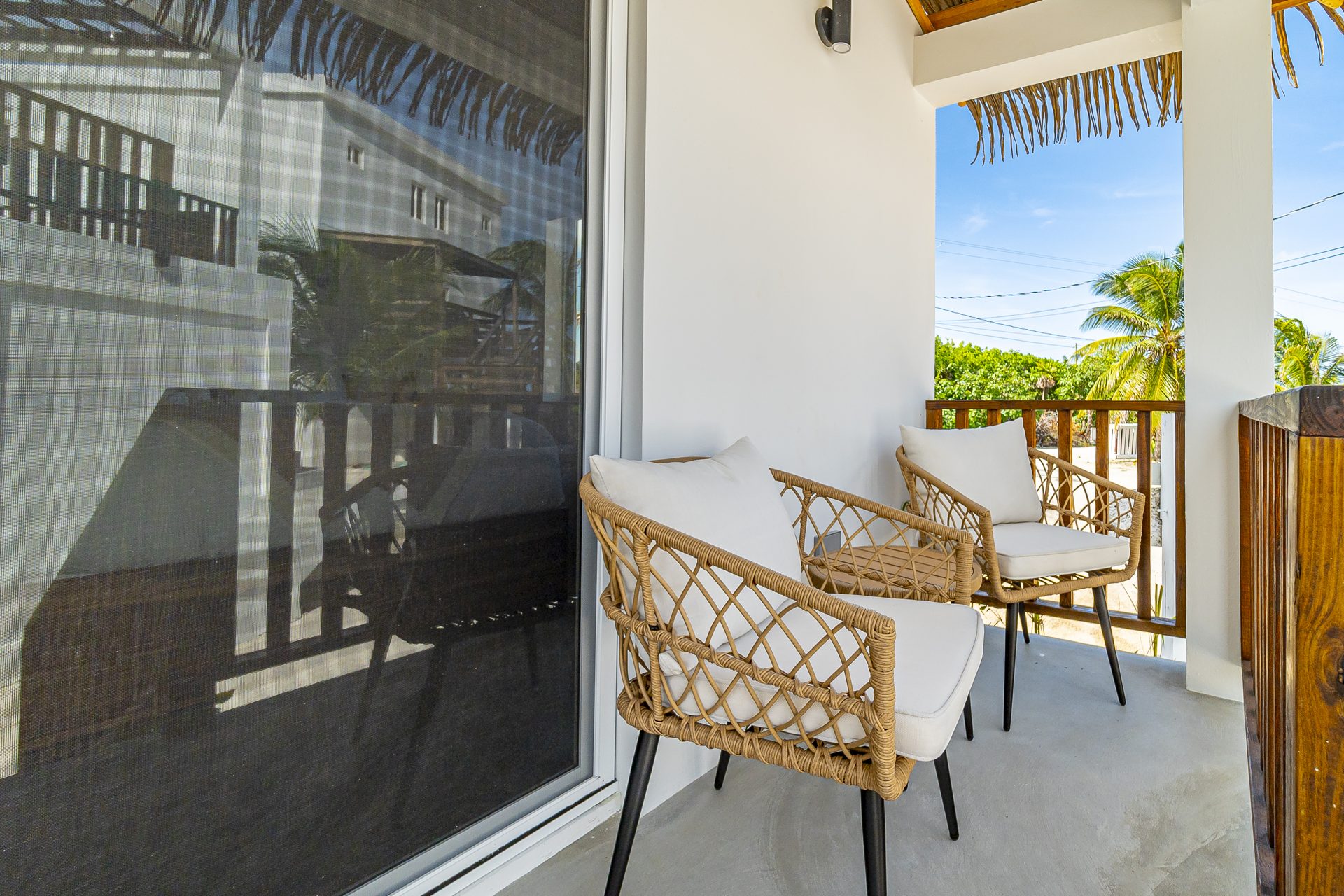 Two rattan chairs on the Tarpon Room porch