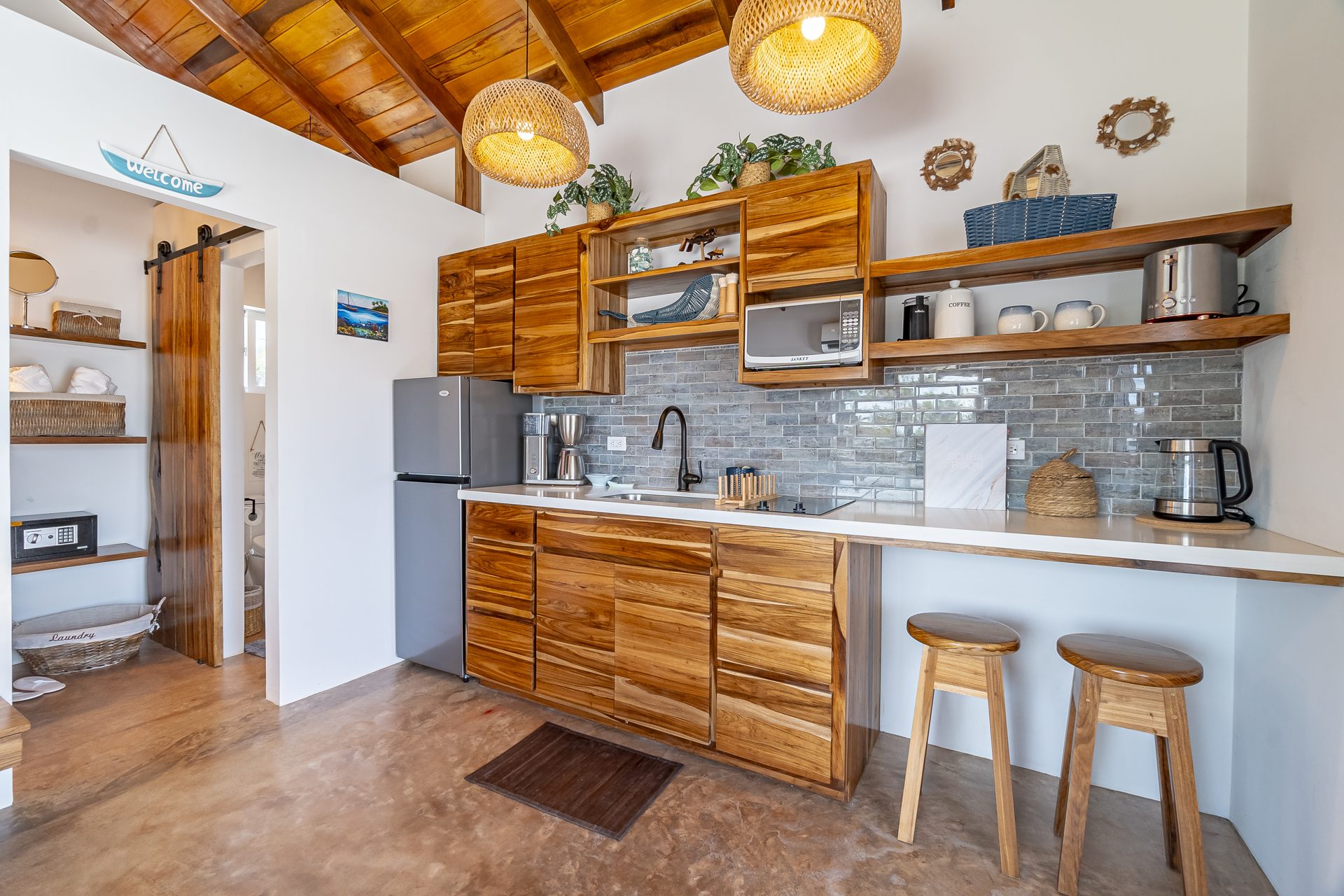 Scuba Room kitchenette with wood cabinets and breakfast bar stools