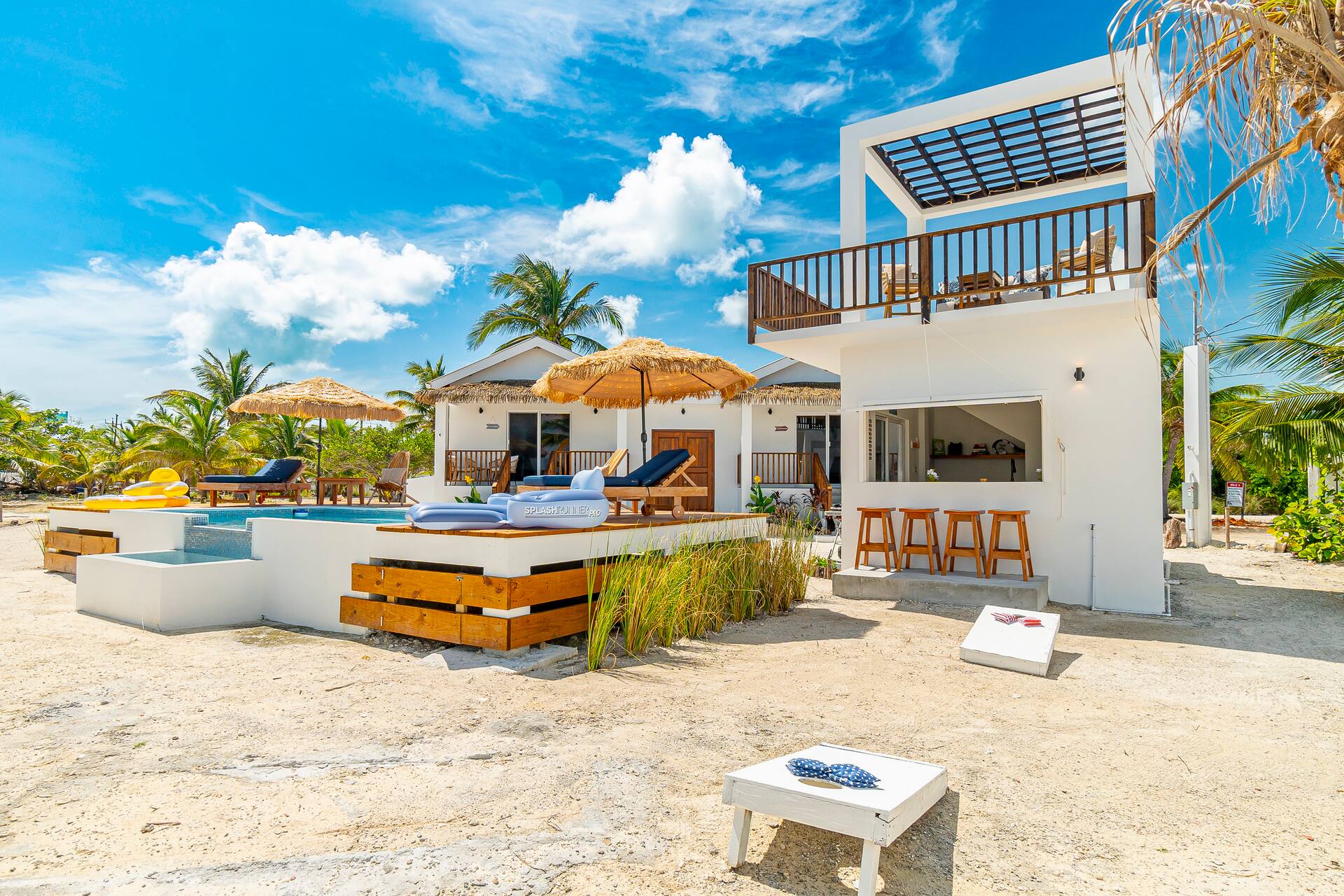 The pool deck in front of the white two-story Seaside Lounge under blue sky