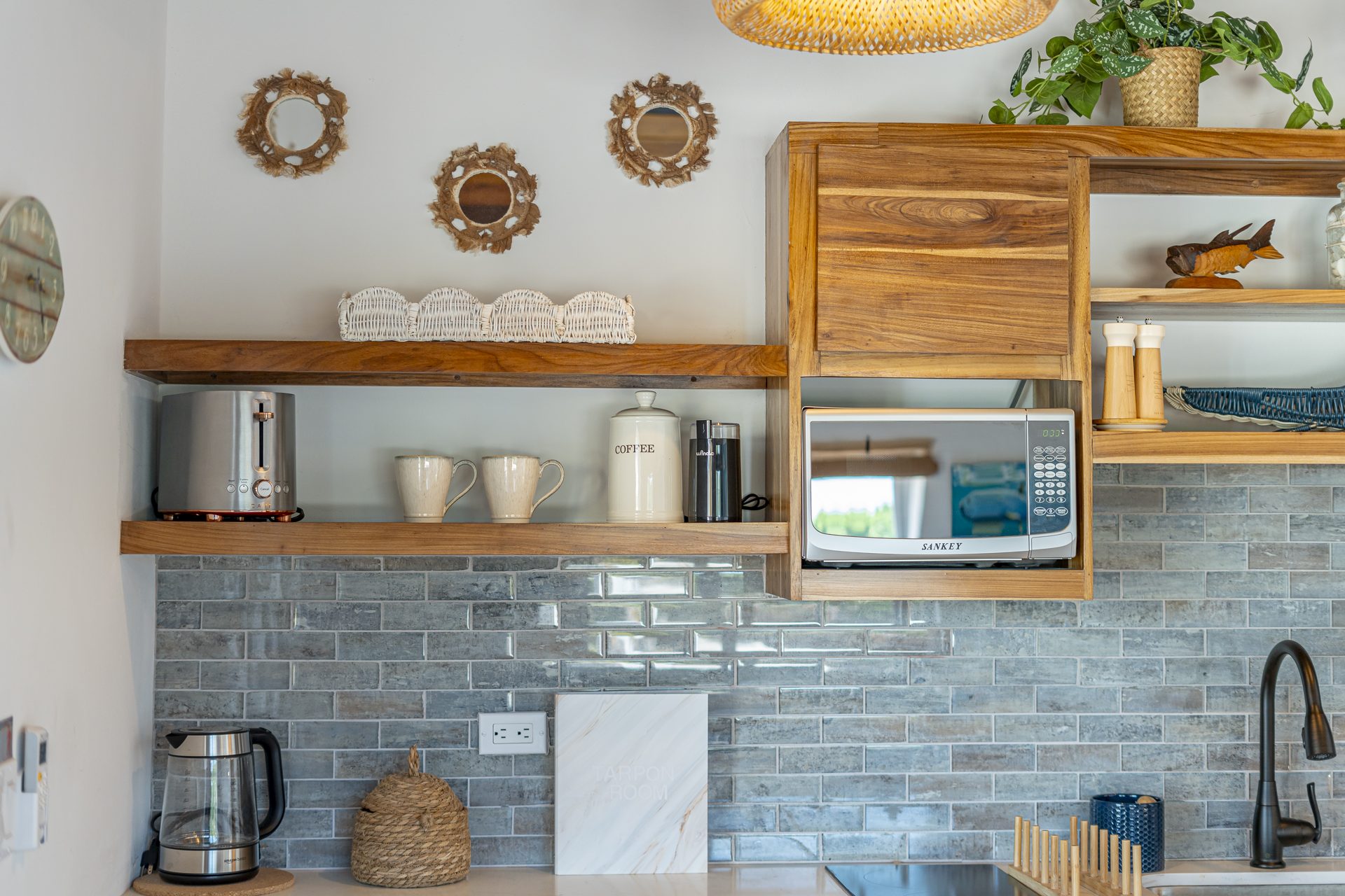 Open wood shelving with mugs and decor in the Tarpon Room kitchenette