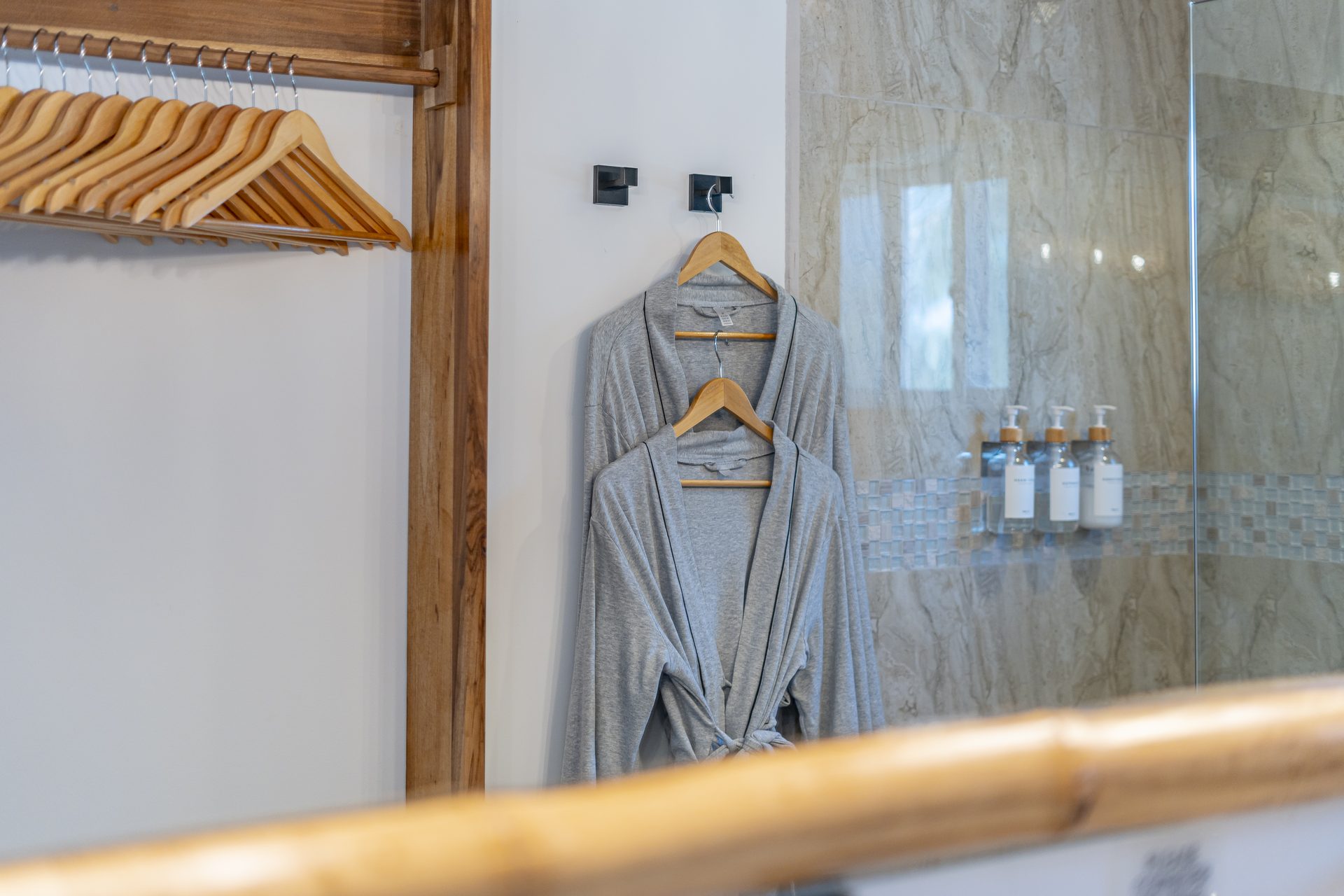 Robes hanging beside the walk-in shower in the Tarpon Room